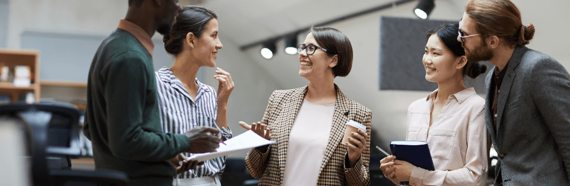 Featured image for ERG Statistics blog post featuring employees standing in an office talking.