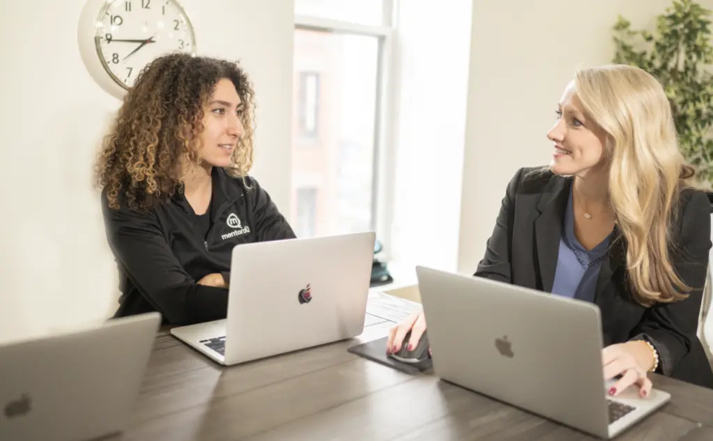 Two women in an ERG mentoring session collaborating. 